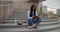 Education in university college concept - young lady reading notebook while sitting outdoors on steps