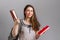 Education. A young woman or teenager with a backpack on her back, happily holding books in her hands