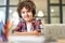 Education your way. Portrait of cheerful hispanic school boy wearing headphones, smiling at camera while preparing