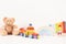 Educational kids toys collection. Teddy bear, wood train, rainbow, wooden educational baby toys on white background