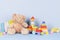 Educational kids toys collection. Teddy bear, wooden train, rainbow color xylophone and baby toys on light blue