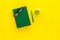 Educational literature. School textbook, book, tutorial, apple and glasses on yellow background top view copy space