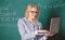 Educator smart clever lady with modern laptop searching information chalkboard background. Learn it easy way. Digital