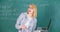 Educator smart clever lady with modern laptop searching information chalkboard background. Learn it easy way. Woman