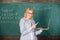 Educator smart lady with modern laptop surfing internet chalkboard background. Basic school education. Woman teacher