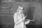 Educator smart lady with modern laptop surfing internet chalkboard background. Basic school education. Woman teacher