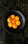 Eegg Yolks on a black rustic plate with a Sprig of Thyme