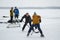 Eenager girl attacking small goal that mature man defending while playing hockey