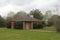 Eerie abandoned structure in rural cemetery on rainy day in Kilgore, Texas