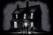 eerie house, with the lights turned off, and silhouetted figures lurking in the windows