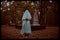 The eerie photo captures a ghost holding a jack\\\'s pumpkin while standing in a graveyard at dusk. Halloween