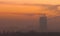 Eerie scenery of the city covered with fog during the sunset