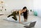 Effective strength exercises. Indian woman working out to online video tutorial, running with her hands on floor at home