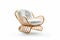 Effortless Elegance: Rattan Lounge Chair with White Cushion on White Background