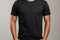 Effortless minimalism black tee on man, capturing uncomplicated yet striking fashion essence