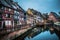 Eflections in the river of the colored houses of Colmar at dawn