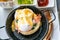 Egg benedict with bacon and sausage - delicious american breakfast