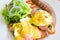 Egg benedict with smoked salmon, sauce, and grill hot dog