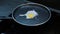 Egg is breaking on induction pan. Close up view of egg cooking process. Frying quail egg on pan on smart kitchen. Cookery concept