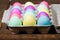 Egg carton of colorful dyed Easter eggs