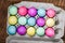 Egg carton of colorful dyed Easter eggs