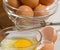 Egg in clear bowl with whisk and egg shells