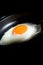 Egg with cutting light on black background with copy space