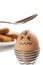 Egg with drawn face, about to be hit with teaspoon
