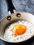 Egg. Fried egg. Chicken egg. Close up view of the fried egg on a frying pan. Salted and spiced fried egg