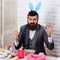 Egg hunt on spring holiday. Bearded man hipster paint easter eggs. love easter. Happy easter. serious brutal male with