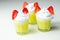 Egg liqueur in shot glass decorated with fluffy whipped cream and pieces of strawberry in the shape of bunny ears
