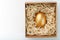 Egg made of gold in a wooden box on a white background. The concept of exclusivity and superprize. Minimalistic composition