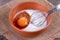 Egg with milk in a deep bowl with a whisk
