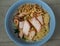 Egg Noodle with Sliced red roasted pork and Wonton, Streaky pork with crispy crackling in blue bowl