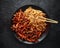 Egg noodles with bean sprouts and Crispy shredded beef on black plate