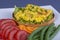 Egg omelette on a piece of fried bread with green beans, red tomato and carrot on a plate, close up. Breakfast concept