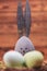 Egg-rabbit figure with big iron ears near easter eggs