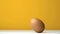 Egg revolving against yellow background