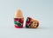 Egg in Russian wooden traditional doll. Minimal Easter concept on a light blue background