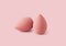 An egg-shaped makeup sponge placed on a pink background