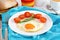 Egg with tomato on the plate with bread