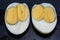 An egg with two yolks. Double yolk hard boiled egg. Close-up of an egg with two yolks