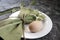 Egg on a white plate with a napkin and the first spring flowers of snowdrops. Easter decoration with flowers. Festive table