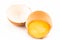 egg yolk in egg shell, cracked egg white isolated on white background