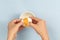 Egg yolk in a hand on blue background