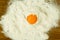 Egg yolk on a pile of flour