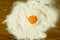 Egg yolk on a pile of flour