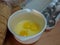 Egg yolks and whites in bowl with egg carton and sliced bread
