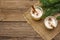 Eggnog cocktail in two glasses arranged with christmas decoration on old wooden table. Evergreen fer tree branch, artificial snow