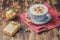 Eggnog. Traditional christmas cocktail, cinnamon sticks on a red napkin and stylish christmas gift box. Wooden background